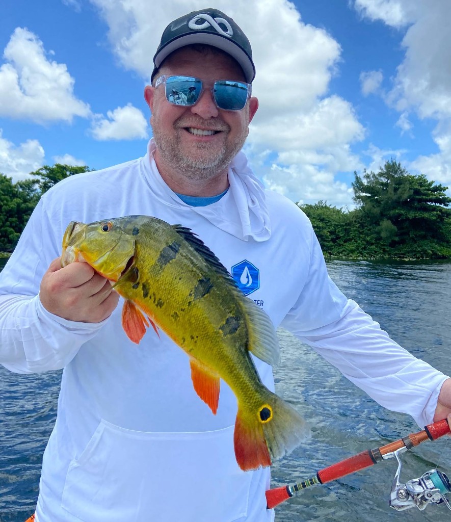 Man holds a fishing pole in Miami