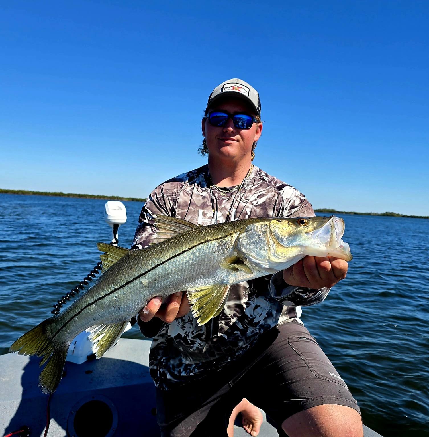 Two people fishing for a snook in Crystal River