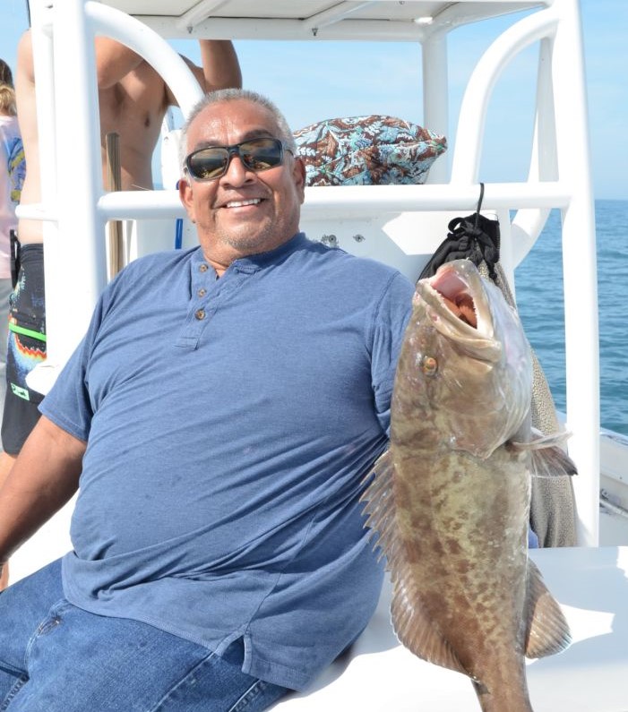 Angler holding a gag grouper in Bradenton Beach
