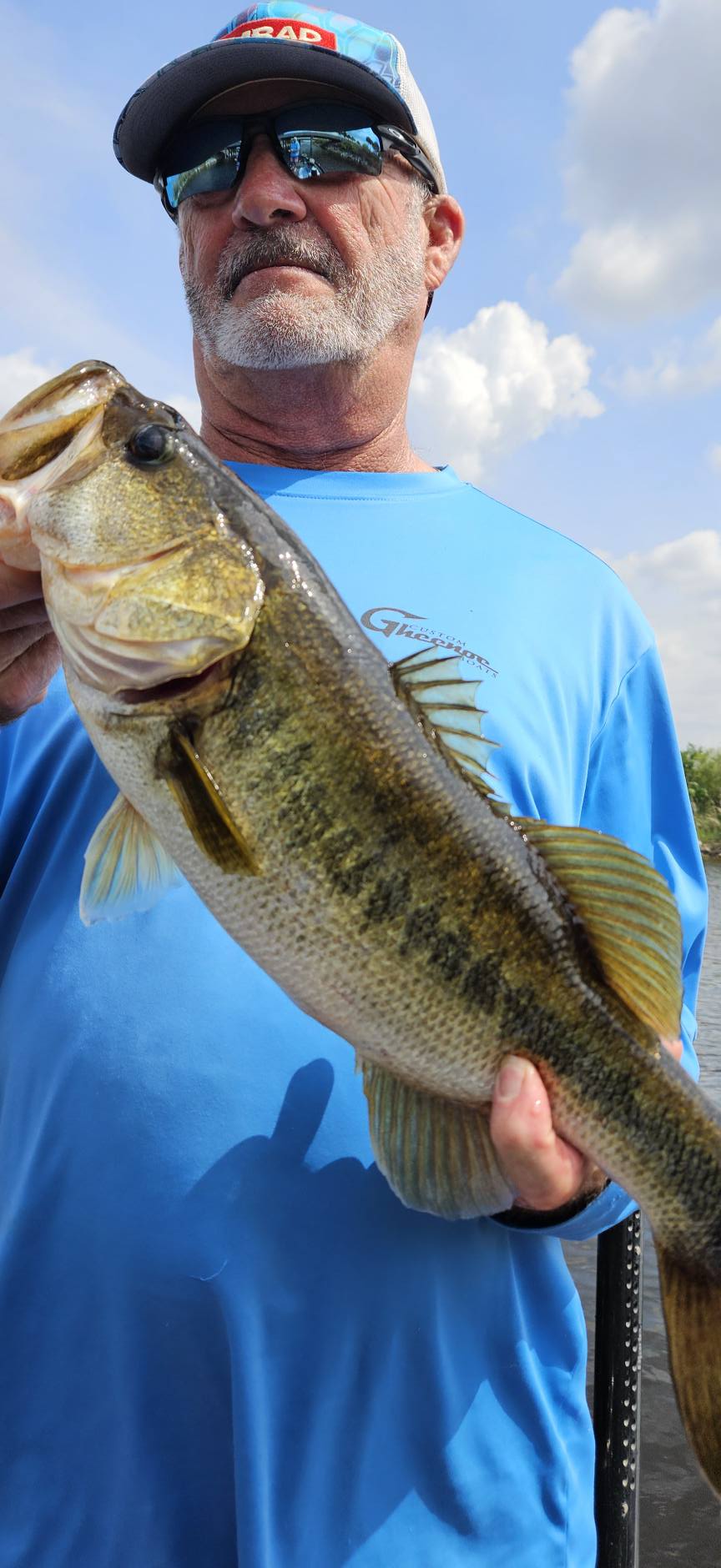 Angler holding freshly caught bass in South Bay FL