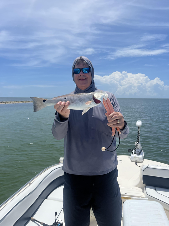 A person fishing in an unknown location