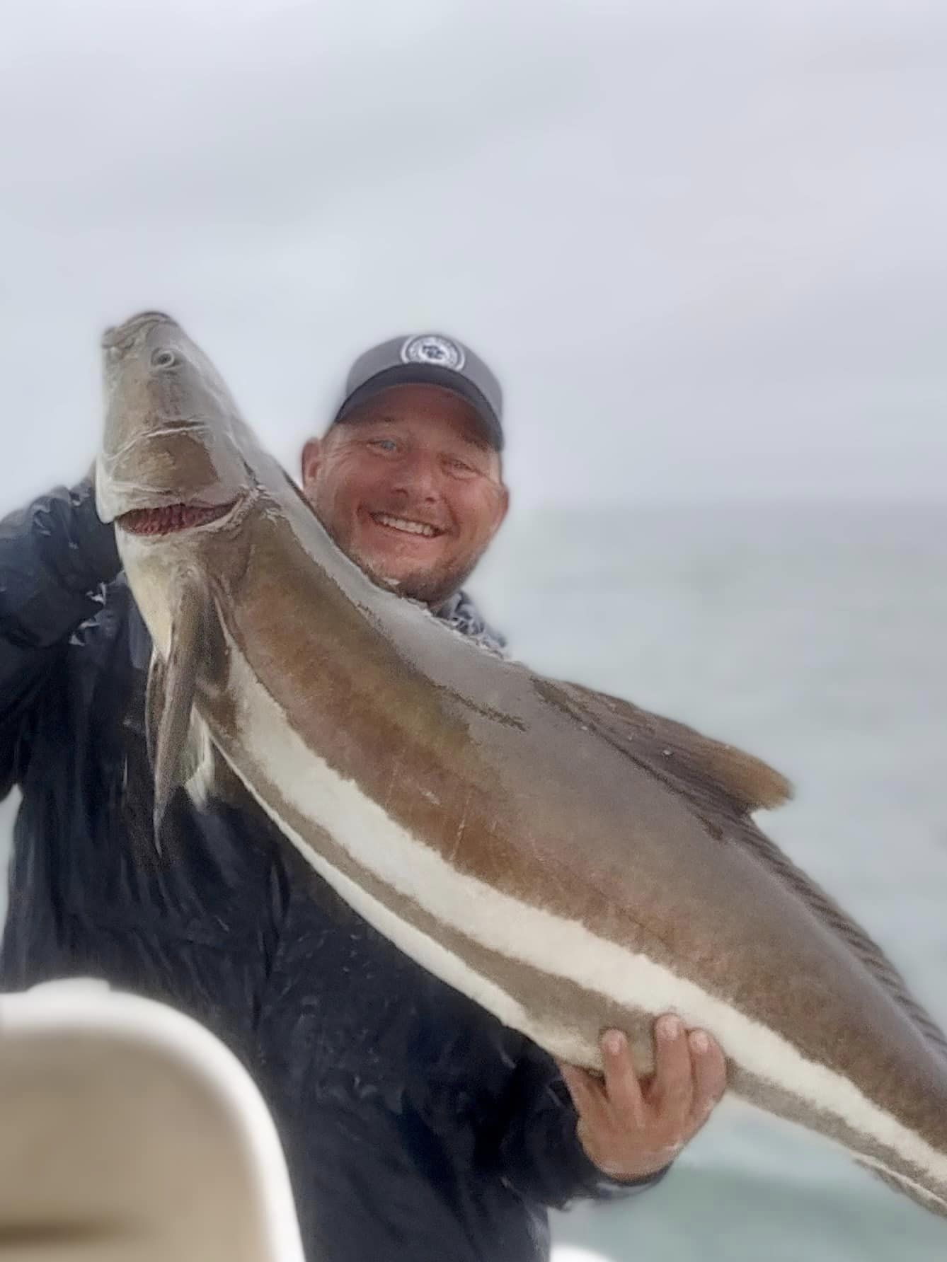 A fisherman with a large wahoo fish caught in Morehead City