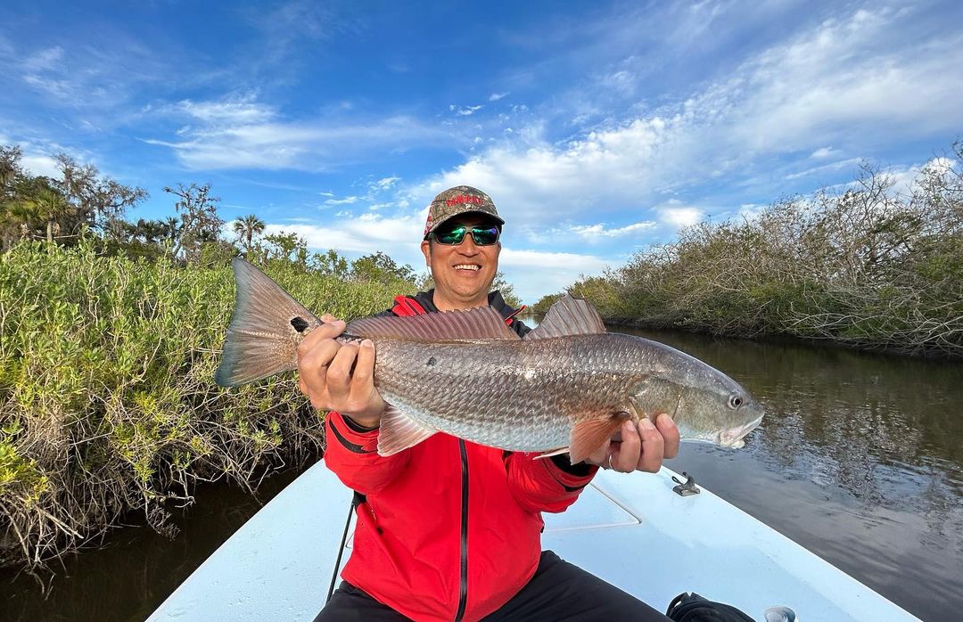 Angler holding a large redfish in Florida