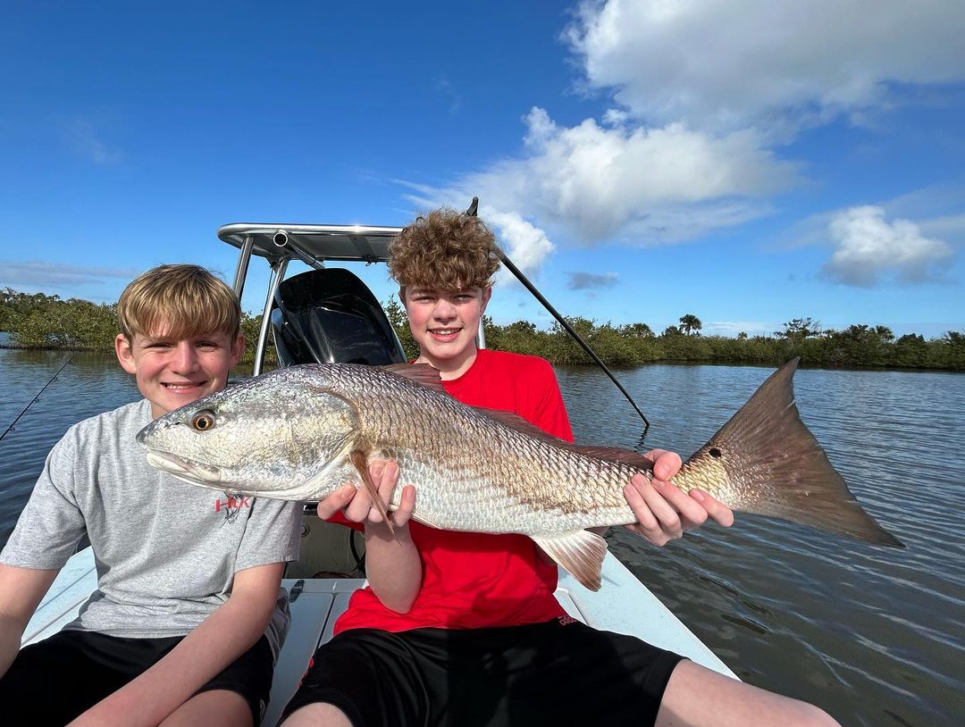 Two anglers with a big 22-inch fish caught while fishing in FL