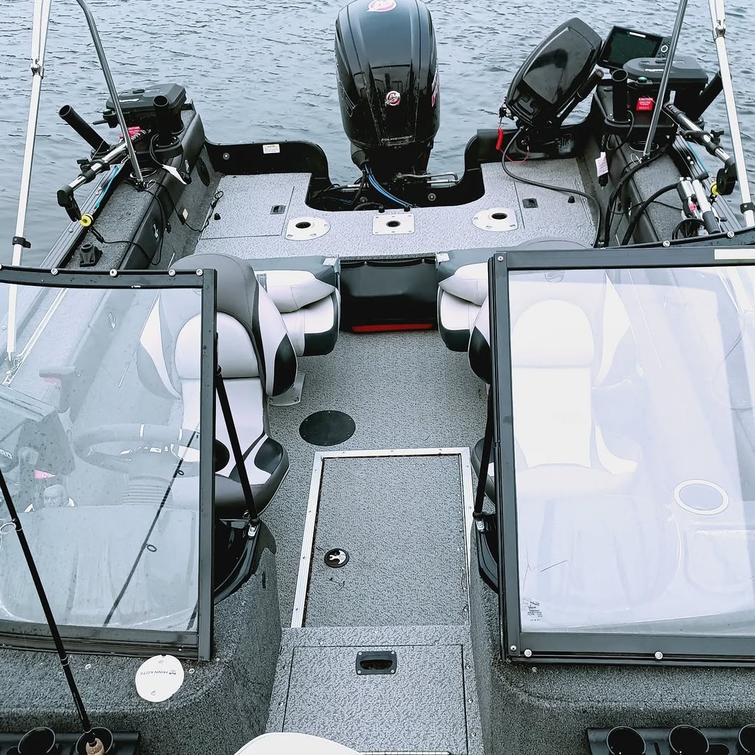 Fishing boat interior showing seats, equipment, and outboard motor at Lantz NS