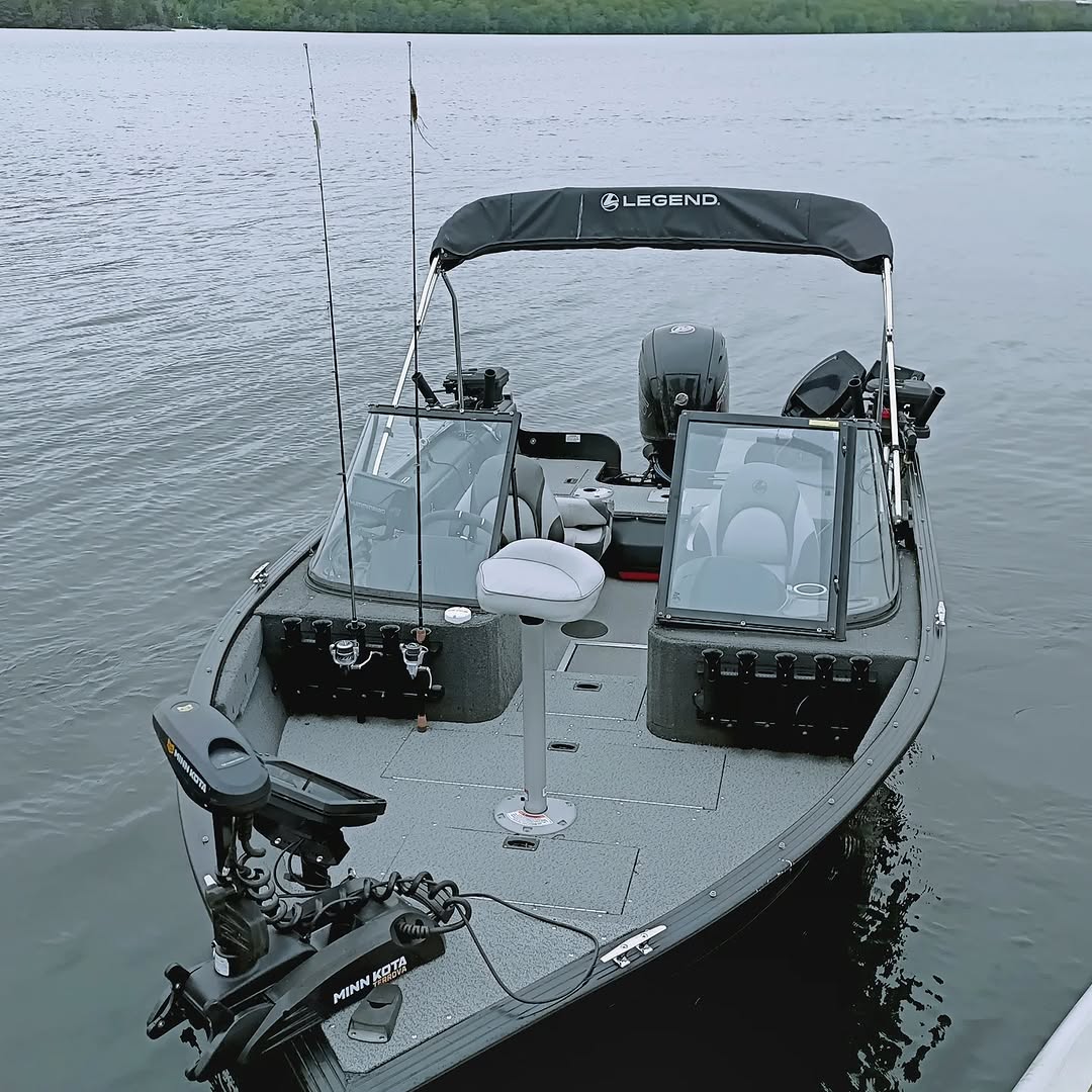 Legend fishing boat with bimini top on calm water in Lantz NS