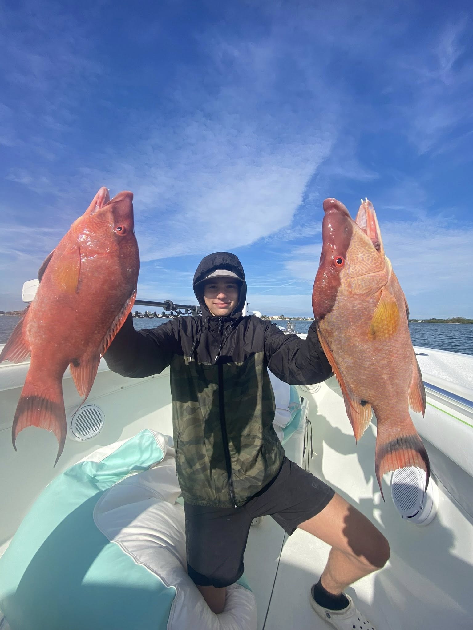 Angler with 2 fish on a boat at Treasure Island