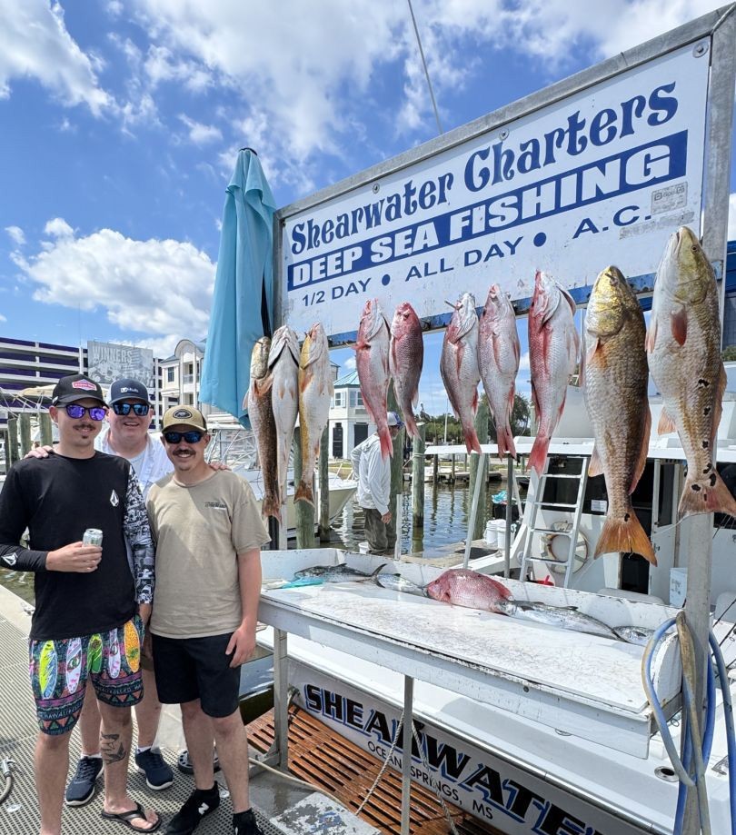 Charter fishing display showing multiple redfish and other species caught in Biloxi MS