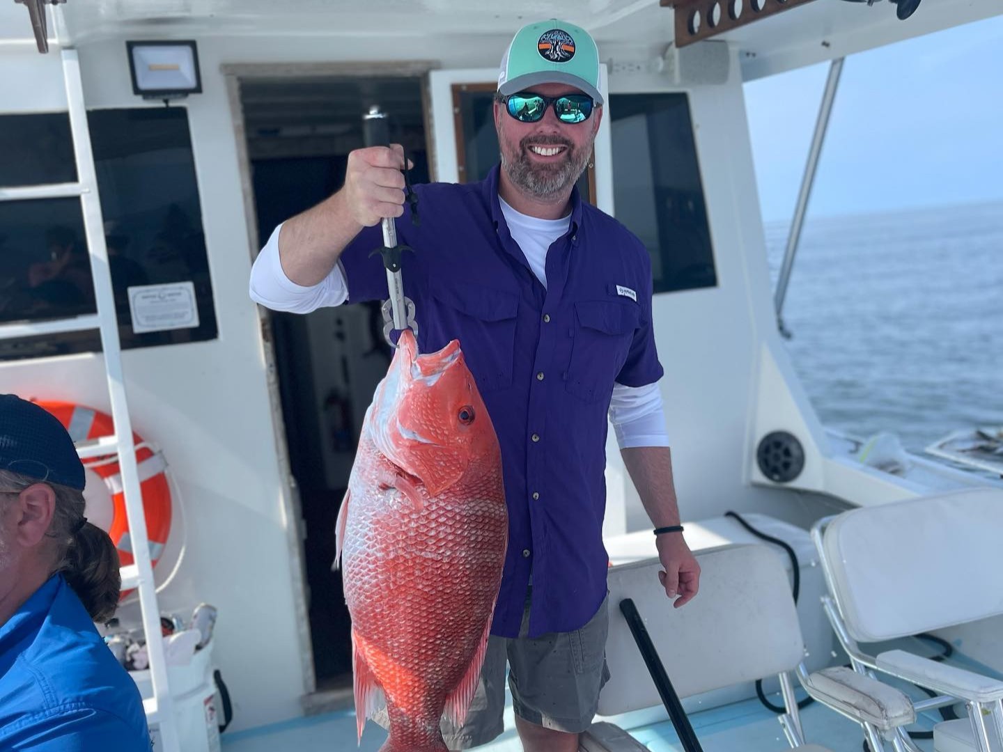 Offshore snapper fishing boat in Gulf waters near Biloxi MS with anglers and fishing gear