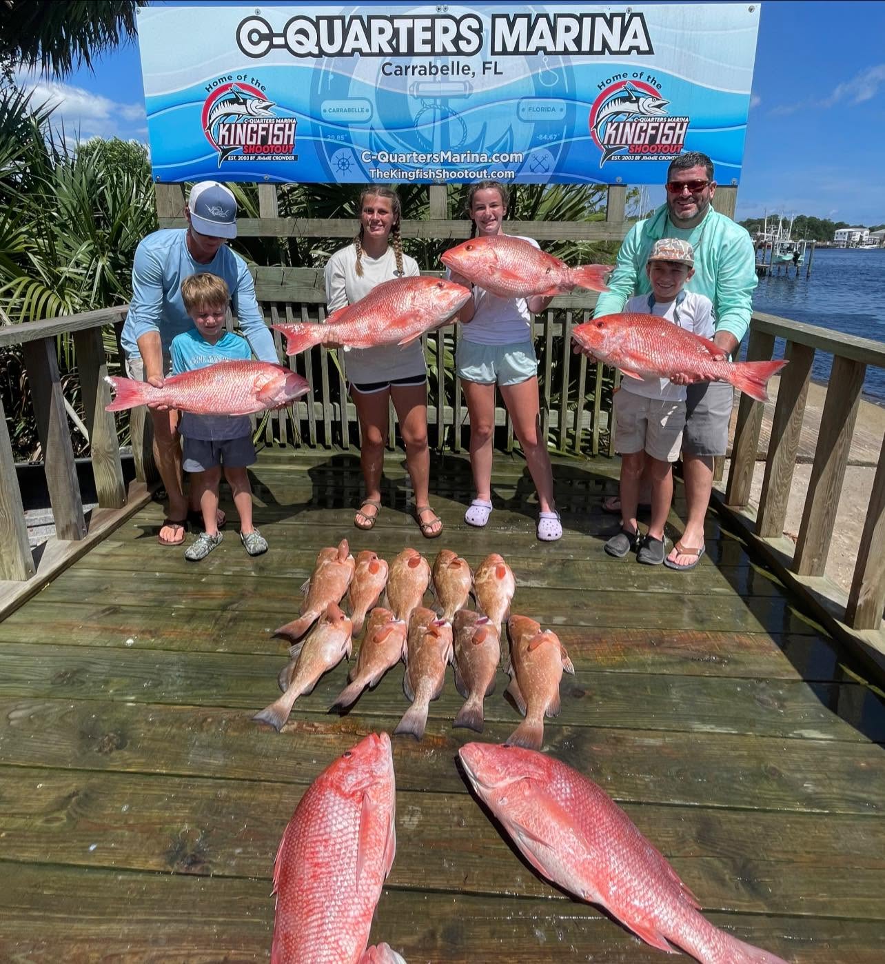 Red snapper and red grouper fishing catch displayed on dock in Carrabelle FL
