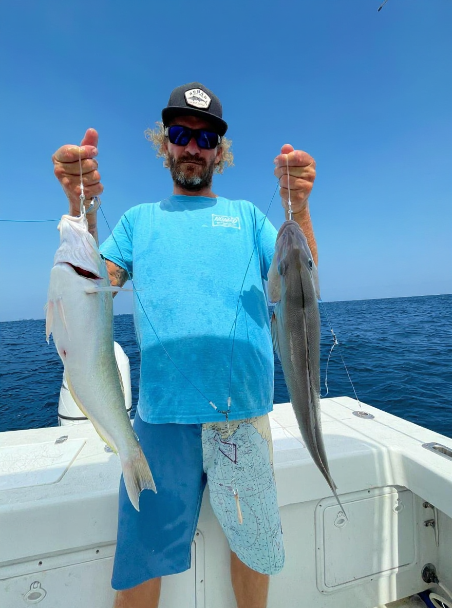 Two fish caught offshore Boynton Beach Florida displayed on fishing boat deck