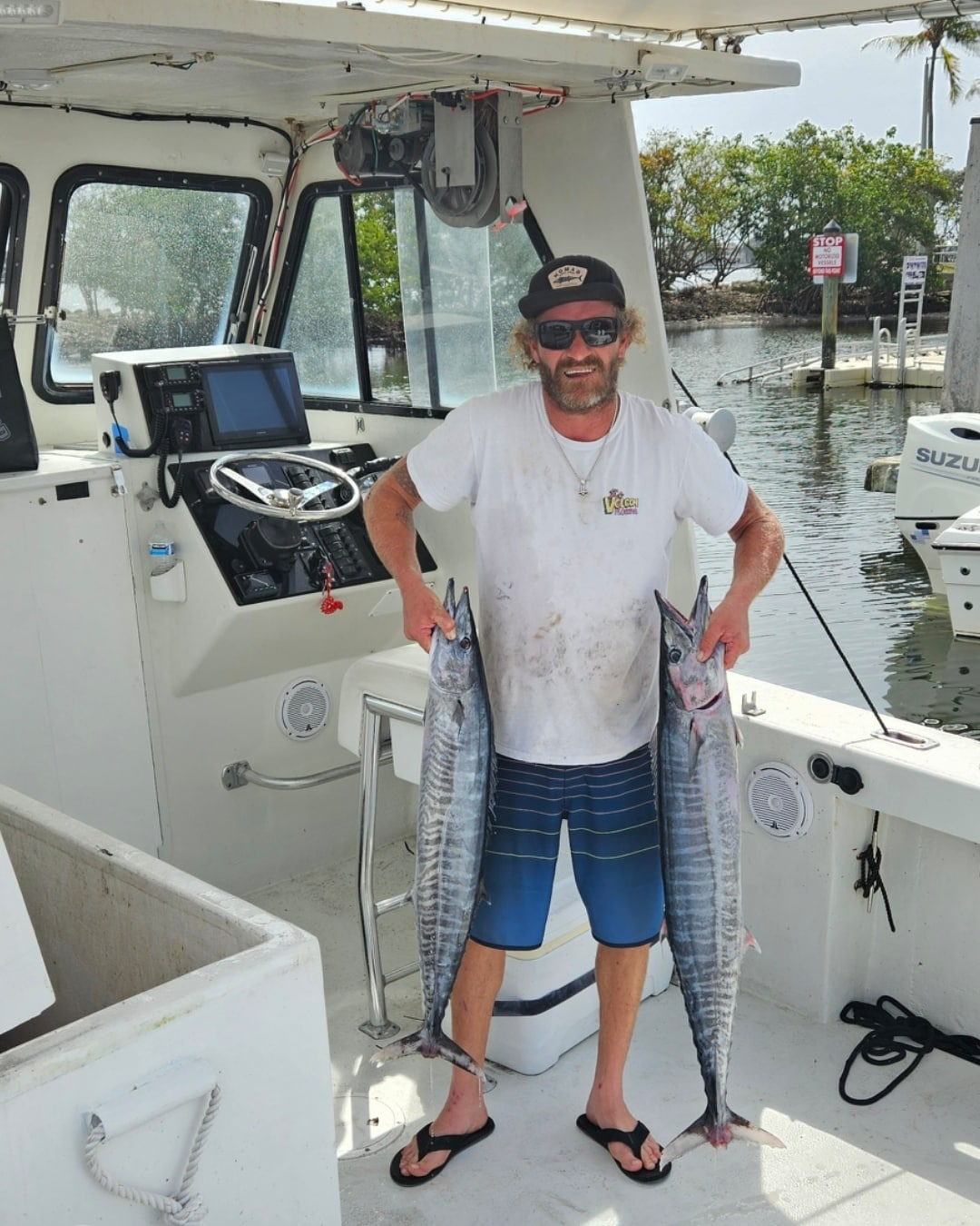 Two wahoo fish caught during fishing trip in Boynton Beach FL displayed on boat deck