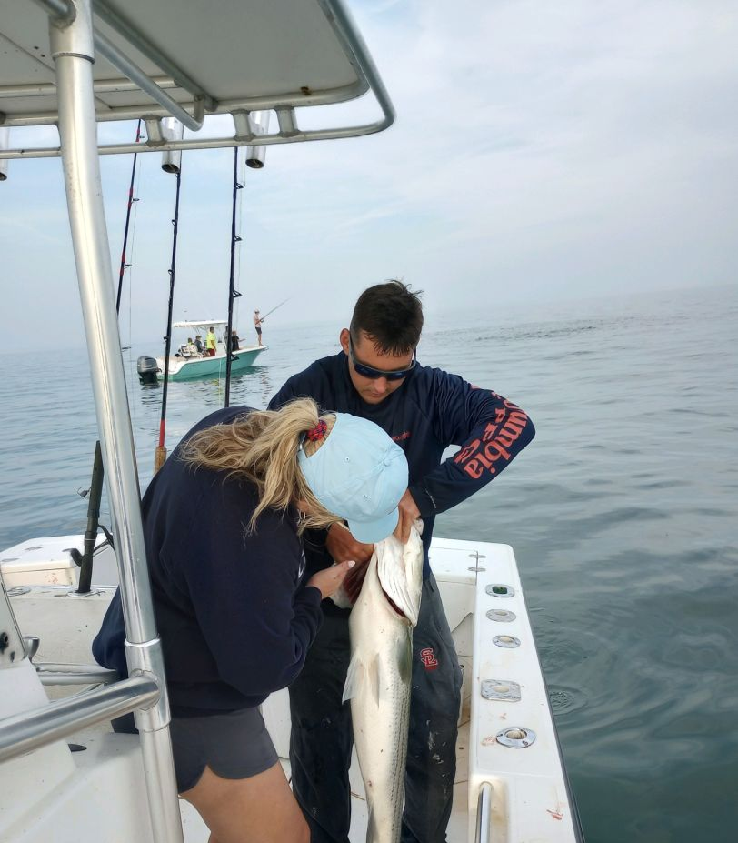 Man fishing with rod in Marshfield