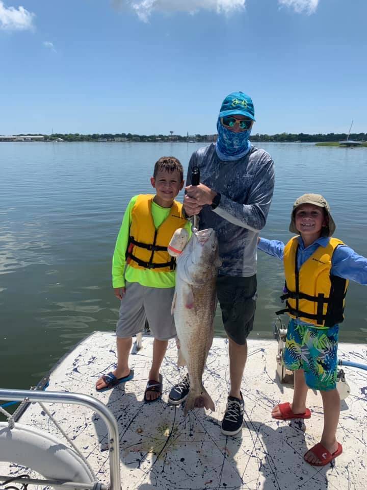 Three people fishing at Fernandina Beach
