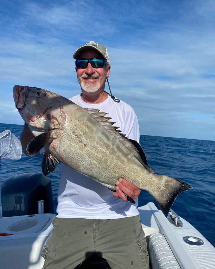 Fisherman catching a 25-inch fish in FL