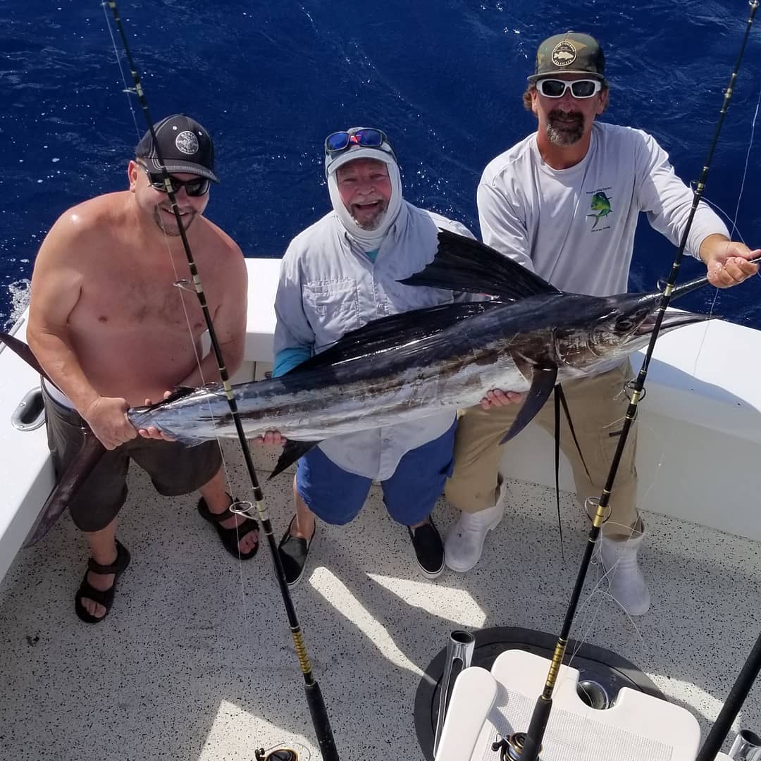 3 people fishing for a big fish in FL