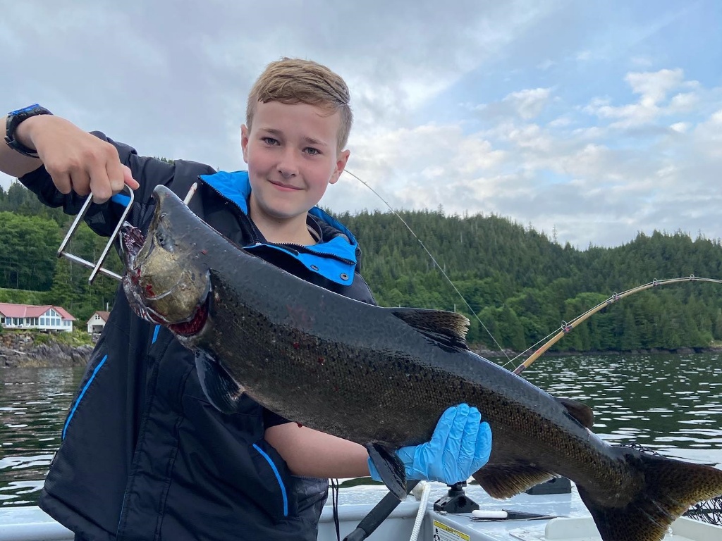 A person standing in Ketchikan, holding a 28-inch fish