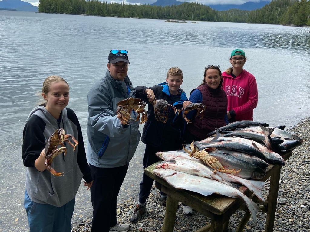5 people fishing for 2 large fish in Ketchikan