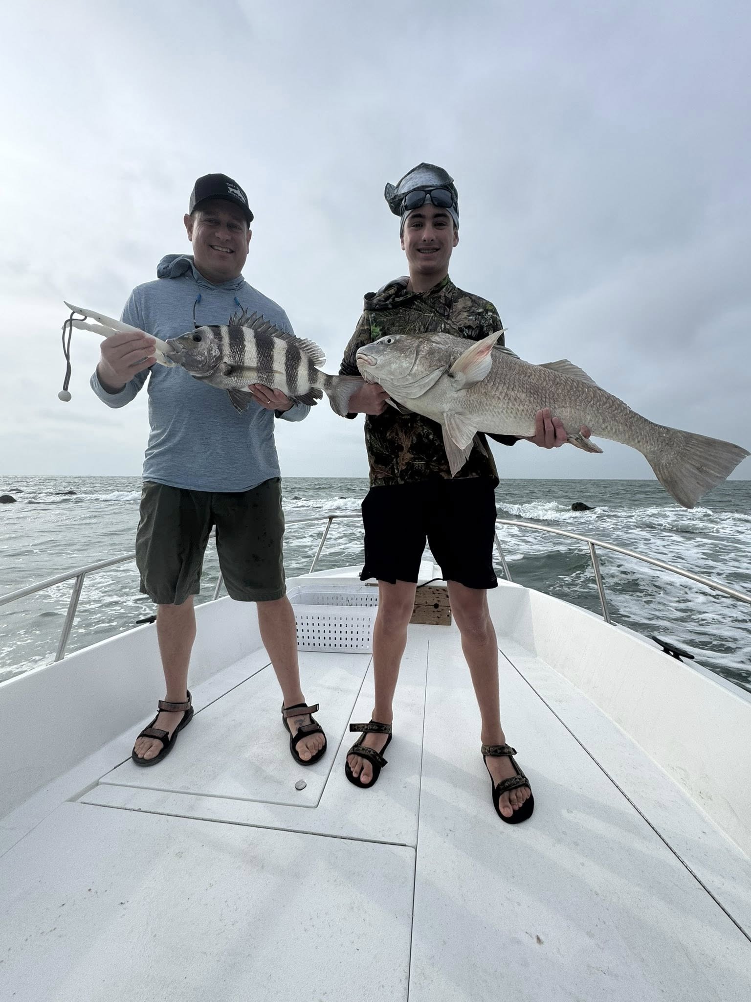 Two anglers displaying black drum and sheepshead caught while fishing in Galveston TX