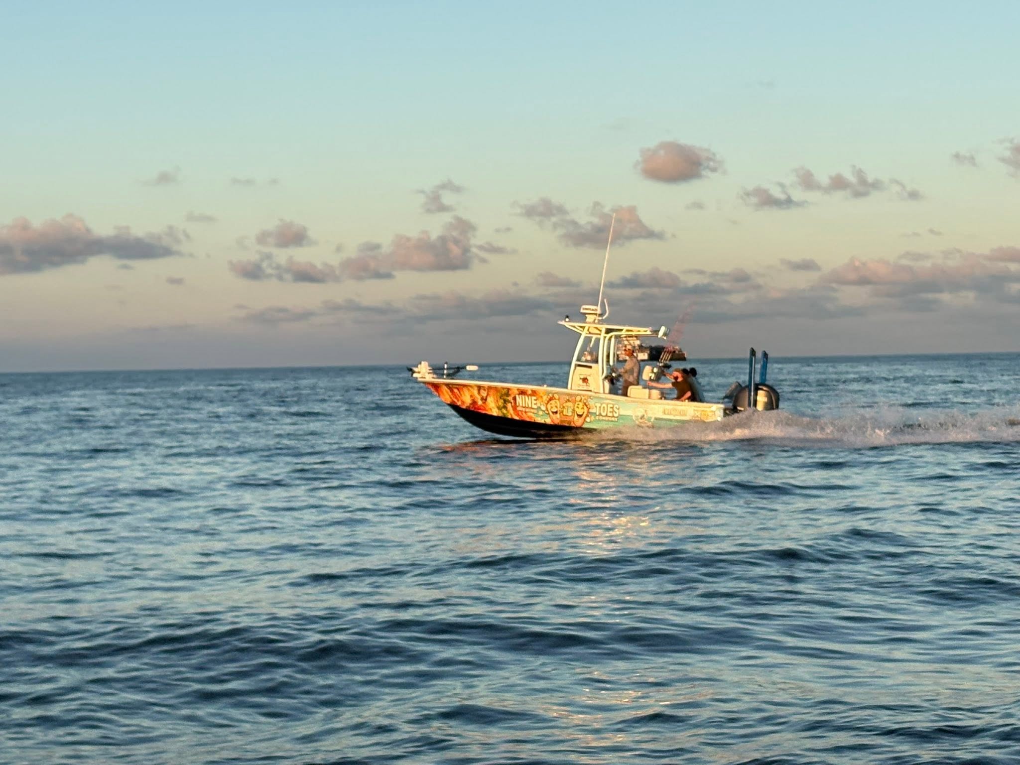 Fishing boat speeding across open water in Bay St. Louis MS
