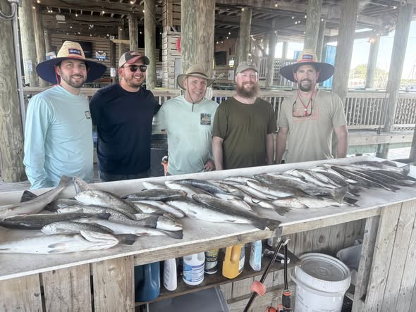 Fishing catch displayed on cleaning table at Bay St. Louis MS dock with multiple fish