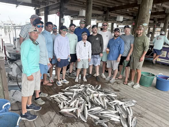 Large catch of fish displayed on wooden dock after fishing trip in Bay St. Louis MS