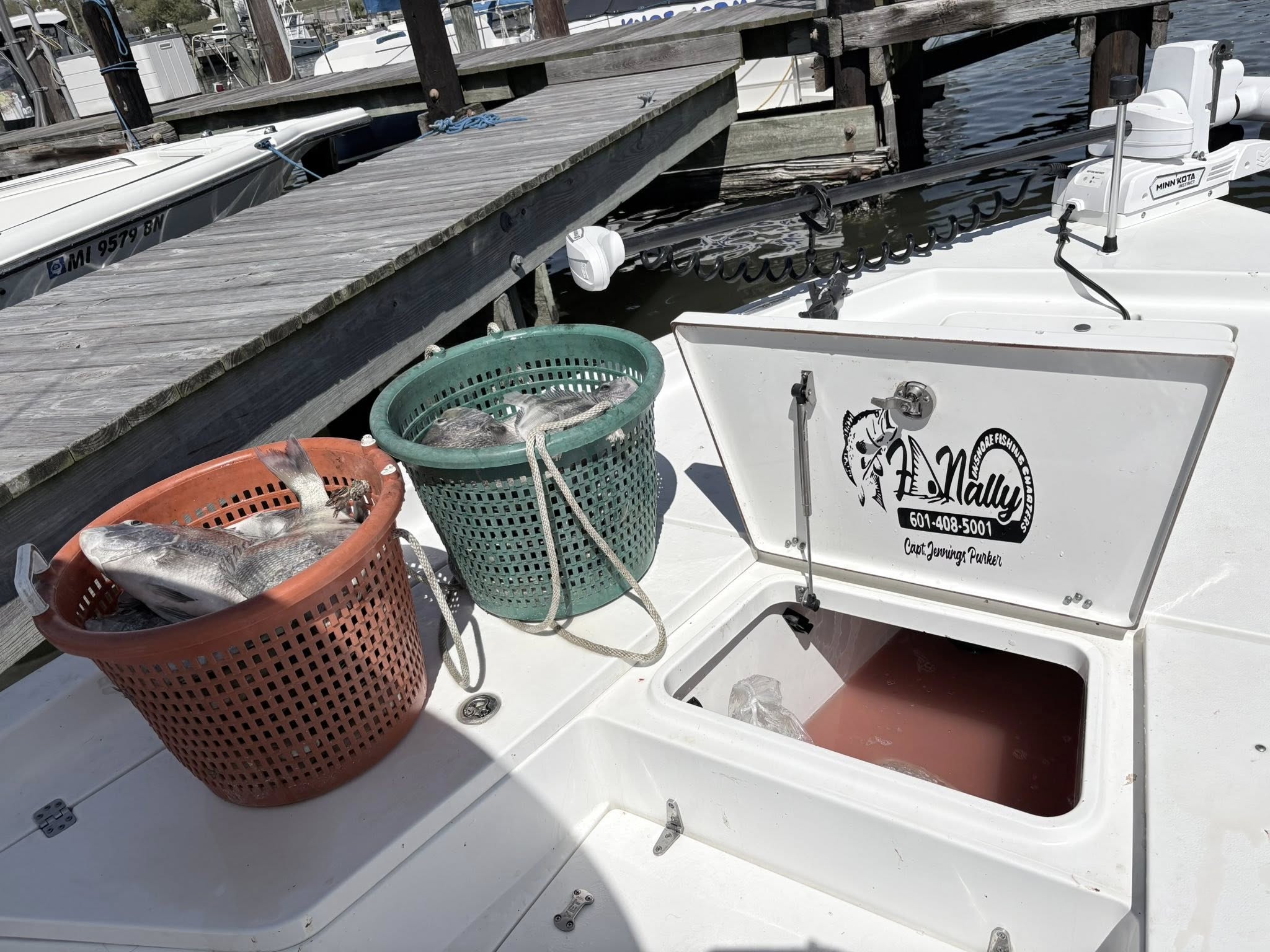 Fresh caught fish in baskets on fishing boat deck at marina in Bay St. Louis MS