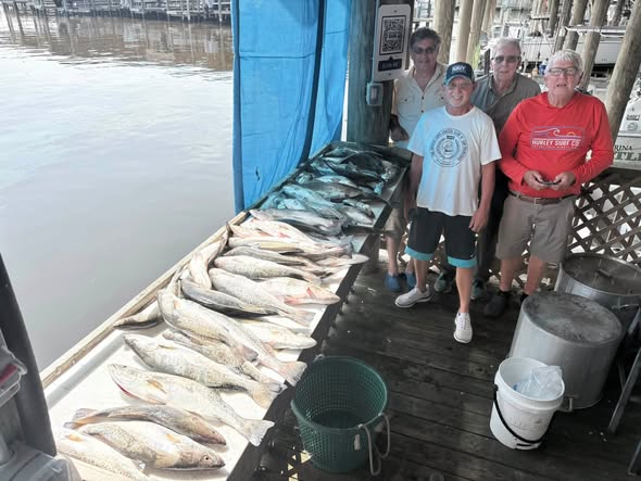 Successful fishing trip in Bay St. Louis MS showing large catch of fish displayed on boat dock