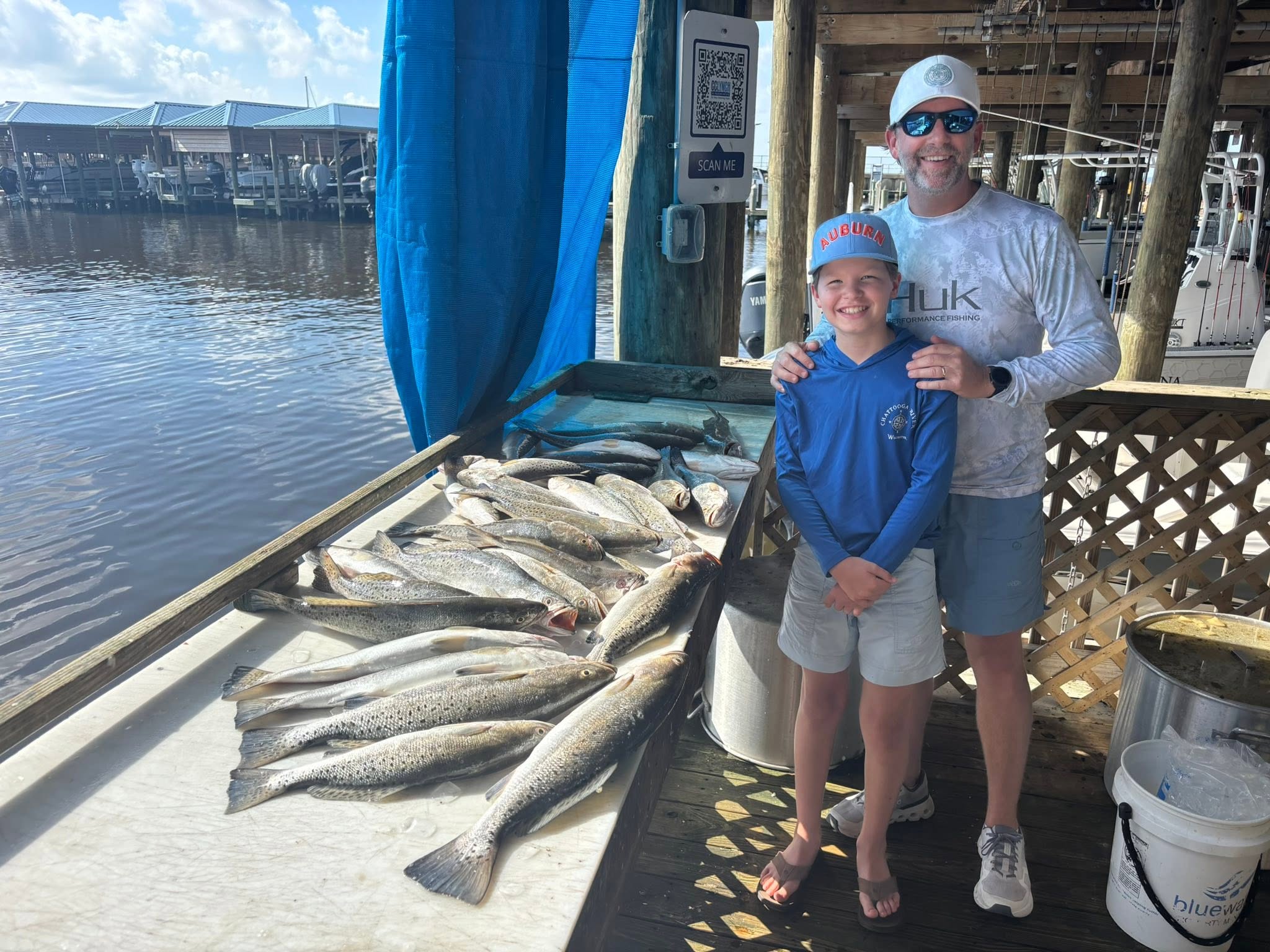 Successful speckled trout fishing trip at Bay St. Louis MS with multiple fish displayed on cleaning station