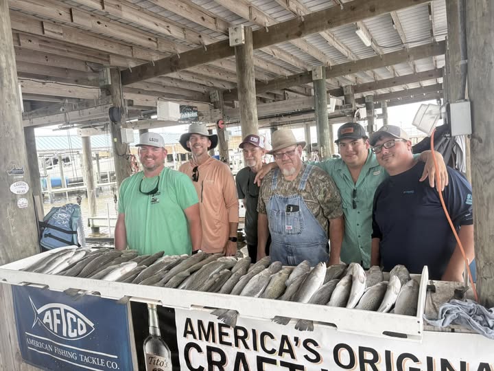 Group of anglers displaying their catch of fish on a cleaning table at a fishing dock in Bay St. Louis MS