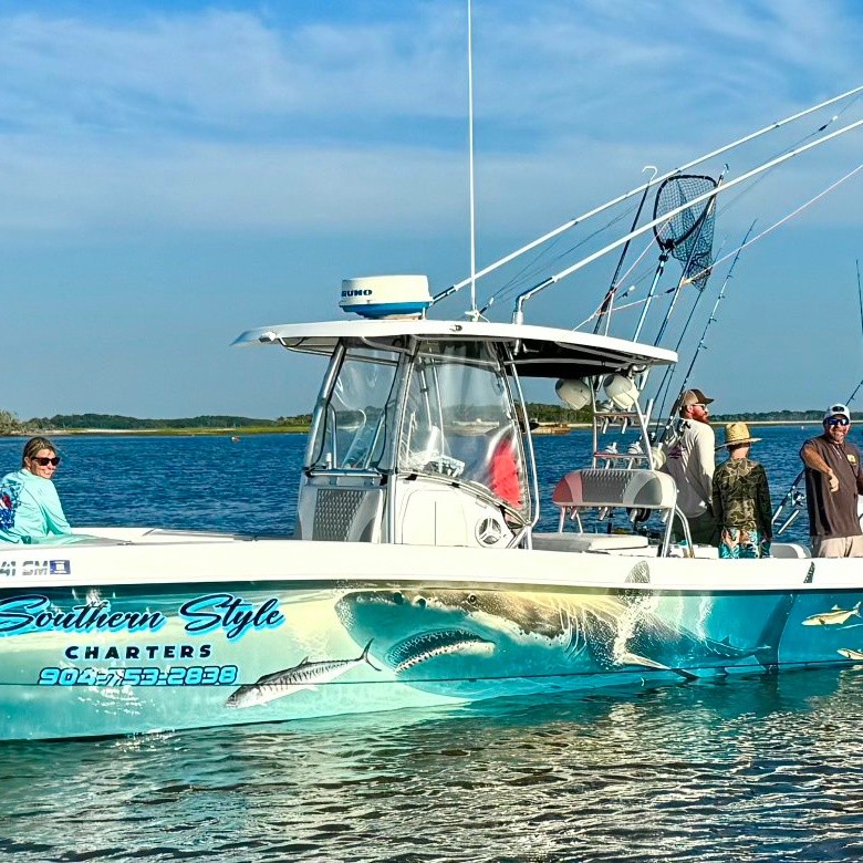 Fishing charter boat with tarpon jumping out of water in Fernandina Beach FL
