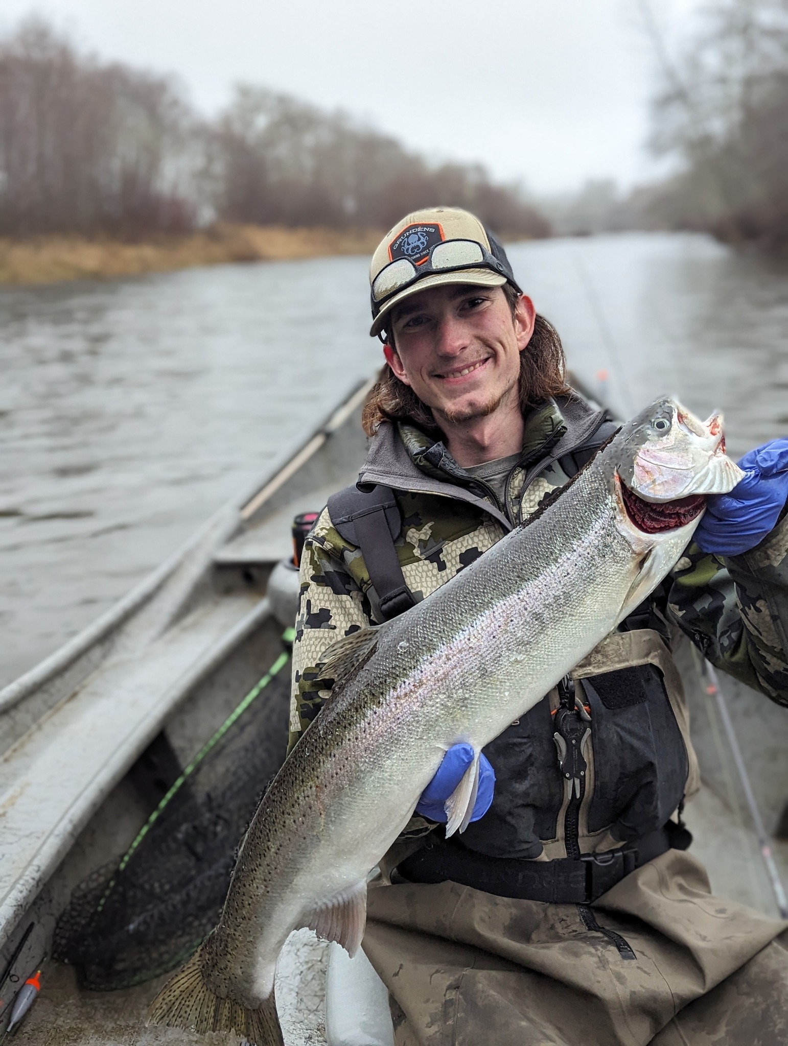 Fisherman with a large rainbow trout caught in WA