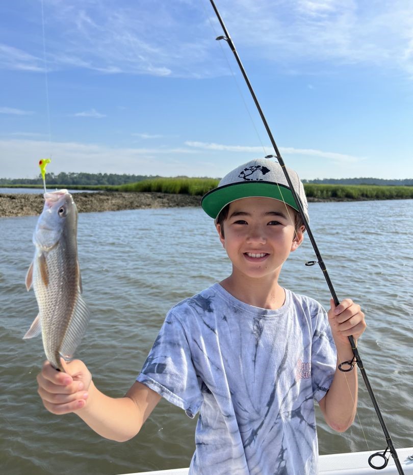 Fresh caught redfish held up on fishing boat in Darien GA waters