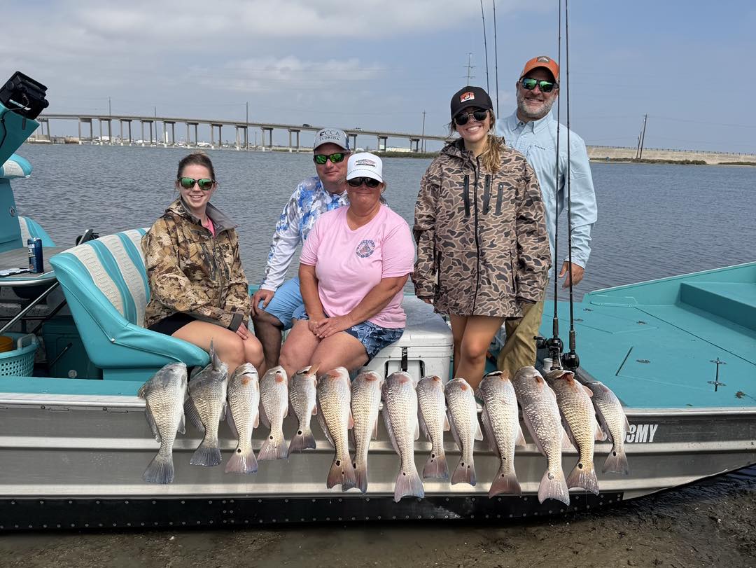 Successful redfish and black drum fishing trip in Rockport TX with multiple fish displayed on boat deck