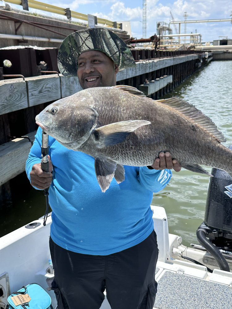 Angler fishing for a black drum in TX