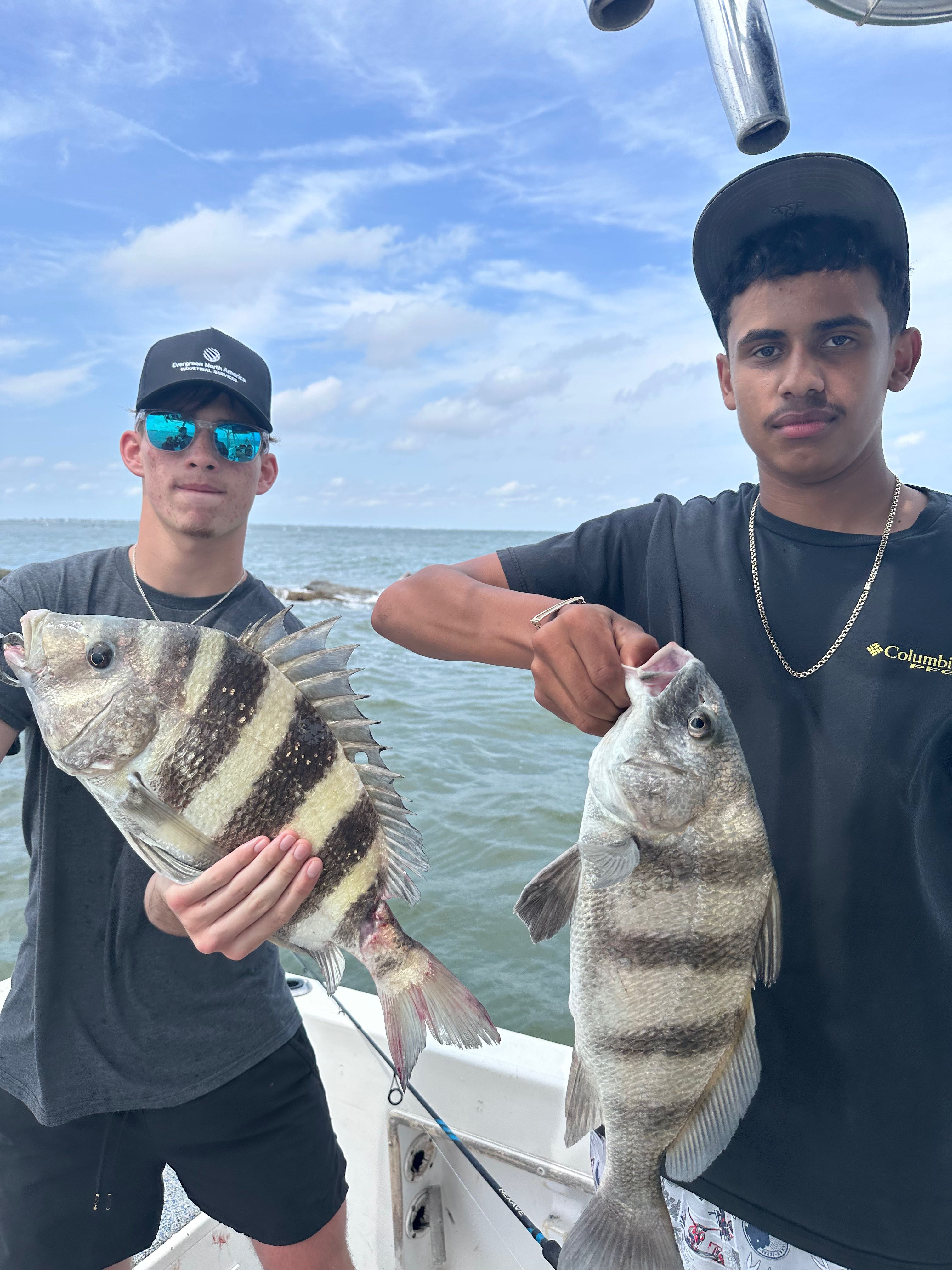 Two anglers holding a black drum and sheepshead caught while fishing in Texas