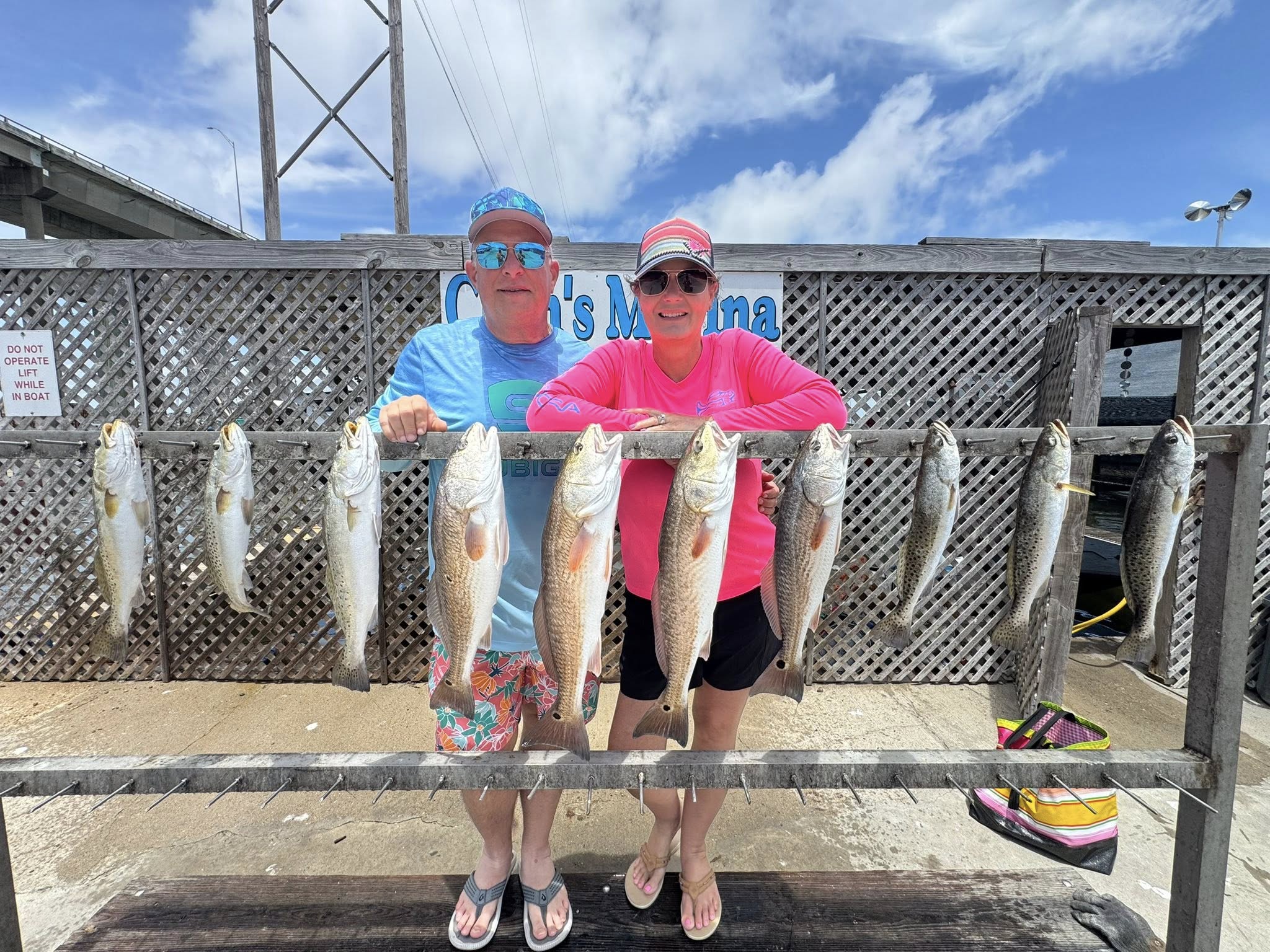 Successful fishing trip displaying redfish and speckled trout catch at marina in Corpus Christi TX