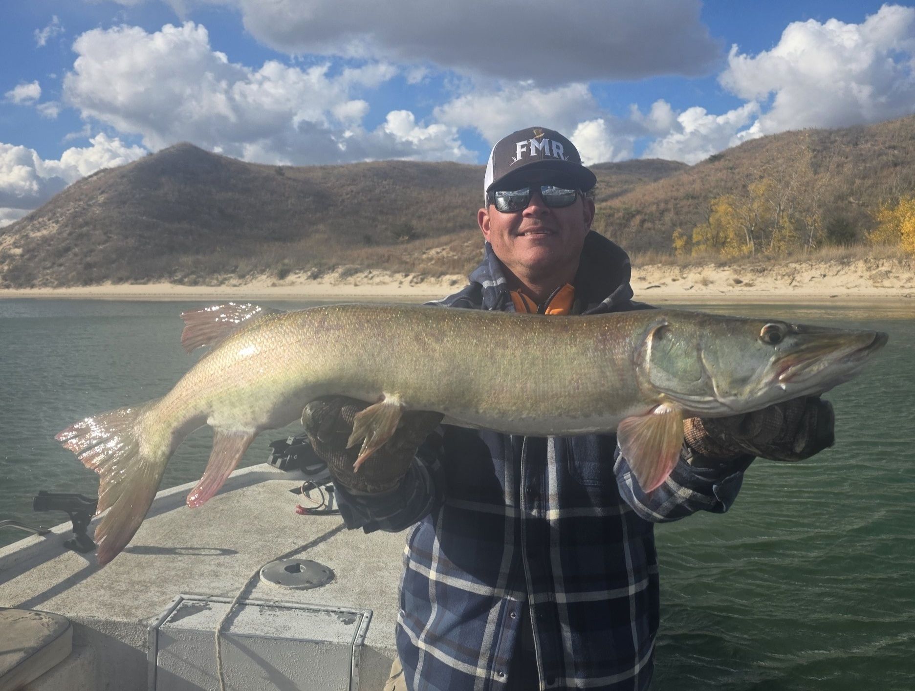 Large muskellunge fish being held on boat in Valentine NE