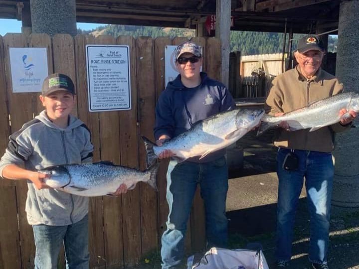 Family salmon fishing boat trip in Gold Beach Oregon with captain and guests aboard 21-foot vessel