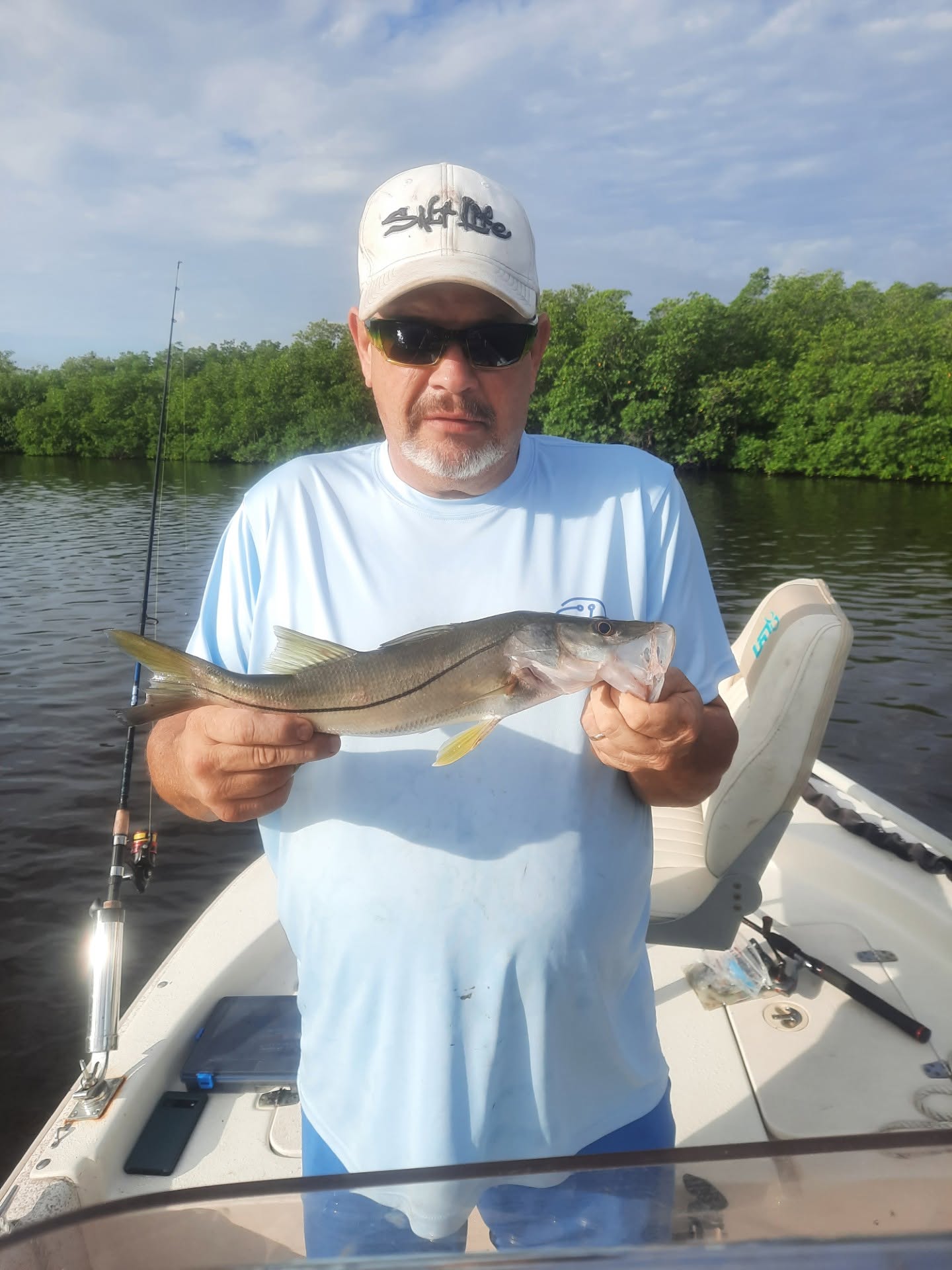 Snook catch on fishing boat in Vero Beach FL waters with mangroves in background