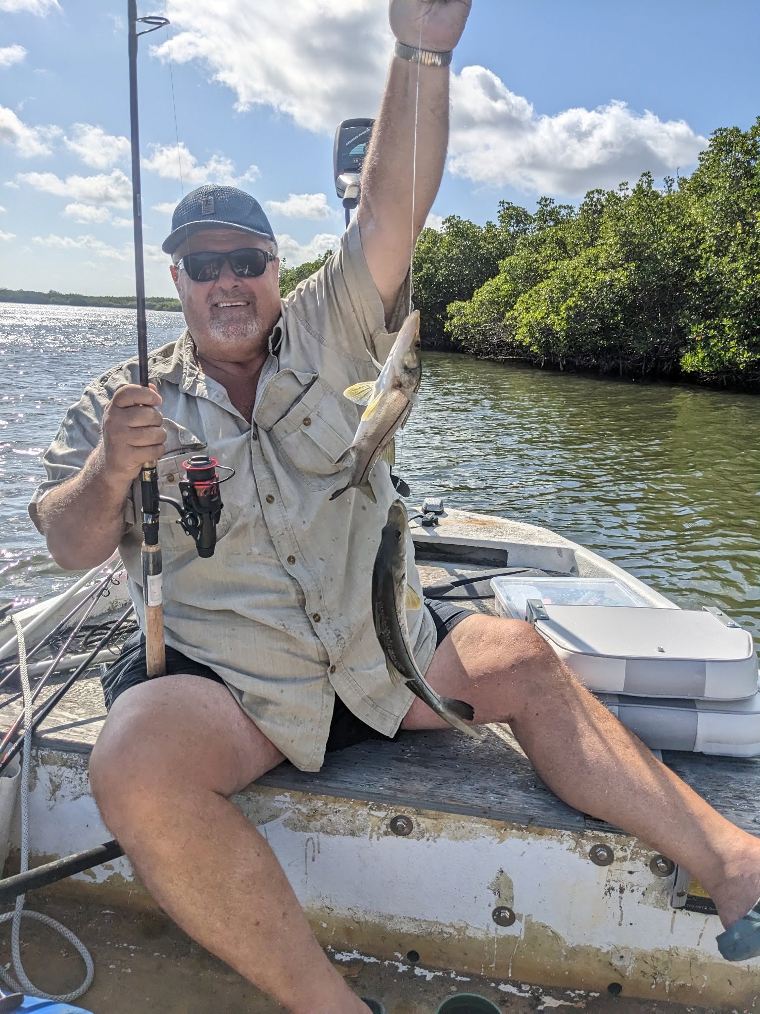 Angler holding freshly caught snook on fishing boat in Vero Beach FL waters