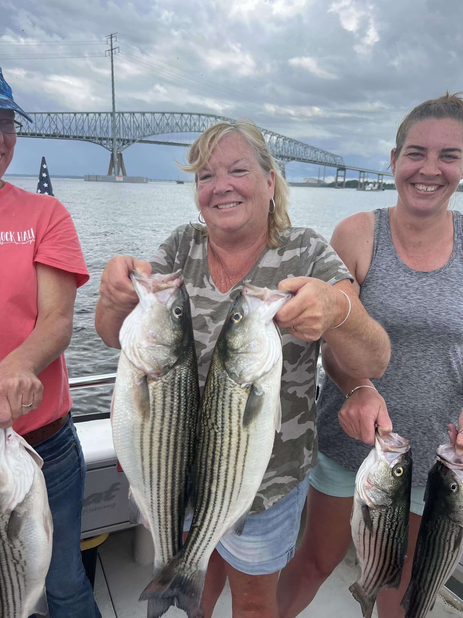 2 anglers with 3 striped bass they caught fishing in Maryland