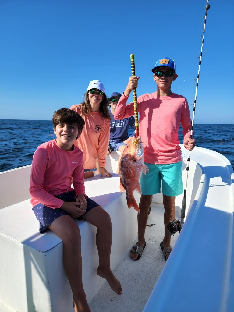 3 people enjoying a day of fishing in Destin