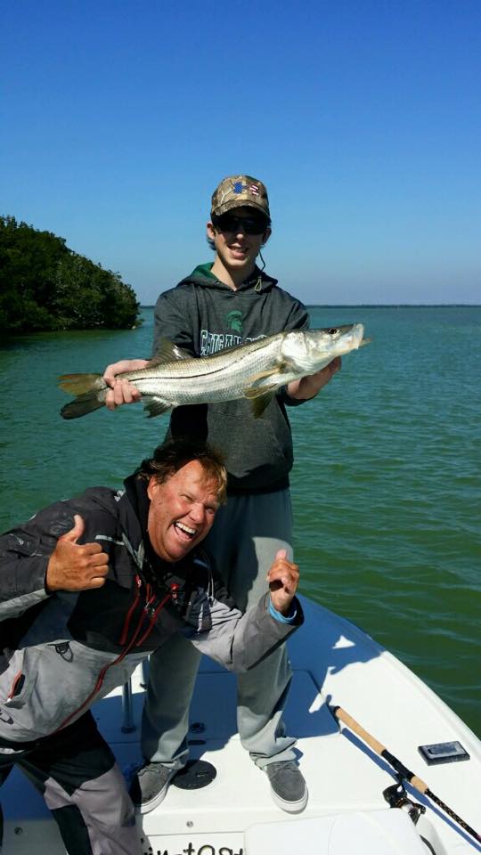 Two people fishing in Islamorada with a 22-inch fish