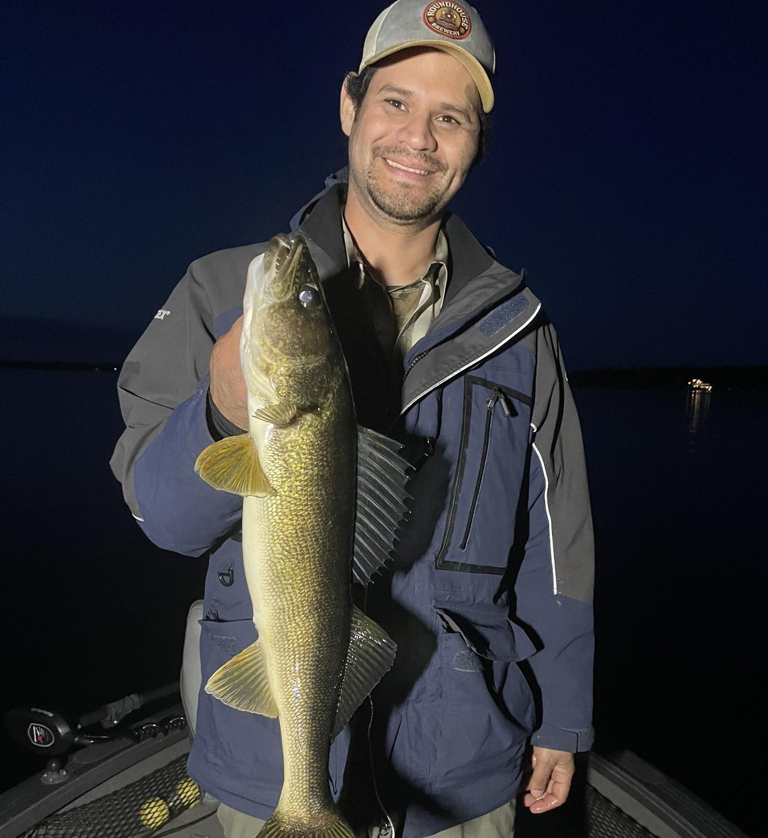 Night fishing boat on Brainerd Lakes targeting walleye with guide and anglers at sunset