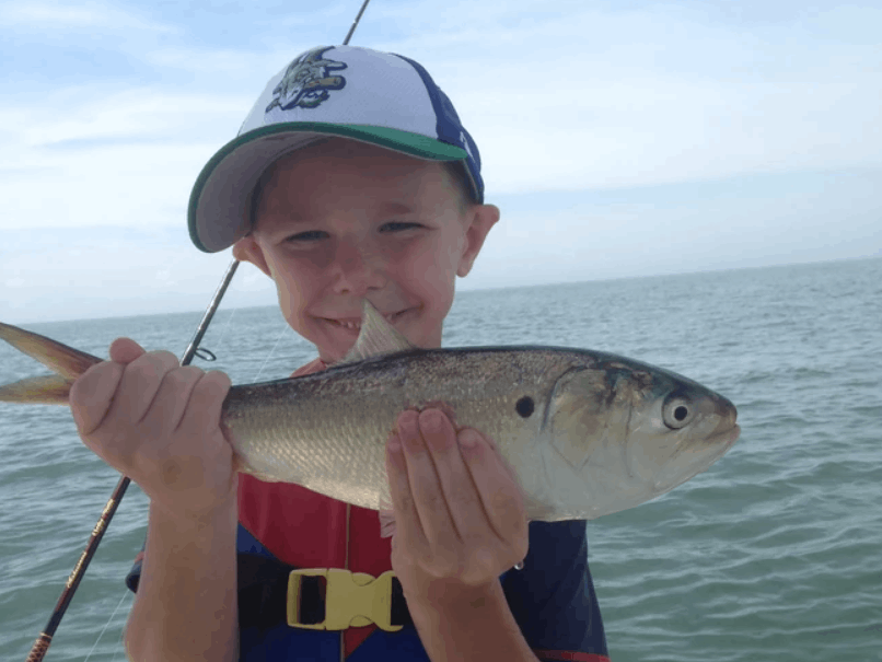 Angler holding a 12-inch fish in CT