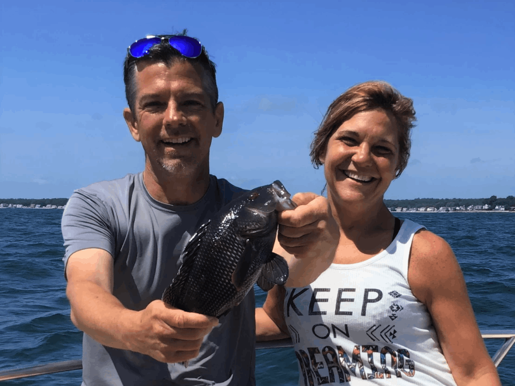 Fisherman holding a sea bass in Old Lyme
