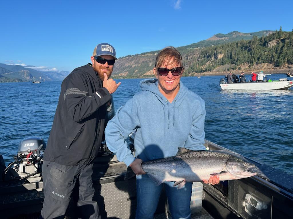 Two anglers with a big fish in the water in Washington