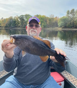 Person fishing in ME with a catch of 1 fish