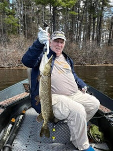 A lone angler fishing in Auburn, Maine